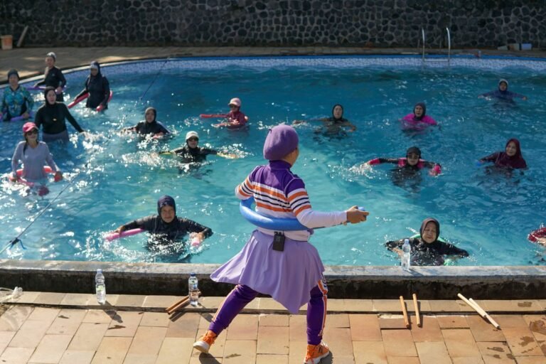 Women participating in a water aerobics class under the sun